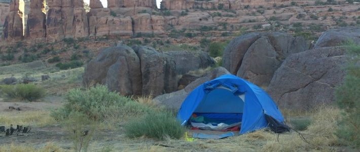 How to Choose the Best Campsite blue tent near rock mountain