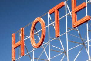 a rusty orange hotel sign